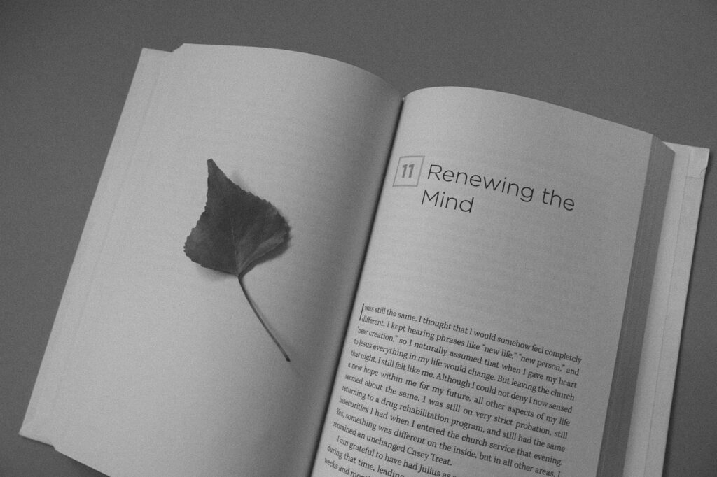 An open book with the page title "renewing the mind" showing. Showing how practicing christian meditation and mindfulness can transform you by the renewing of the mind. 